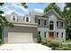 Stunning two-story home featuring a gray brick exterior, attached garage, and a well-manicured front yard at 12411 Herdon Ct, Charlotte, NC 28277