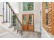 Elegant foyer showcasing a grand staircase, double doors, and natural light from a transom window at 12411 Herdon Ct, Charlotte, NC 28277