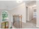 Hallway with carpeted floors and natural light from the arched window, offering a bright and welcoming space at 12411 Herdon Ct, Charlotte, NC 28277