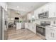 Well-equipped kitchen with stainless steel appliances and a view into the living area with fireplace at 12411 Herdon Ct, Charlotte, NC 28277