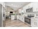 Well-equipped kitchen with stainless steel appliances and a view into the living area with fireplace at 12411 Herdon Ct, Charlotte, NC 28277