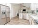 Open-concept kitchen featuring stainless steel appliances and access to the living area with vaulted ceilings at 12411 Herdon Ct, Charlotte, NC 28277