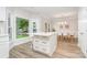 Bright kitchen featuring a white island with quartz countertops, a dining area, and scenic views at 12411 Herdon Ct, Charlotte, NC 28277