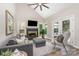 Cozy living room with vaulted ceiling, fireplace, and comfortable seating, open to the outdoor patio at 12411 Herdon Ct, Charlotte, NC 28277