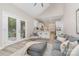 Open-concept living space connected to the kitchen with stylish seating and access to the outdoor patio at 12411 Herdon Ct, Charlotte, NC 28277