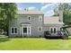 This home features a gray exterior and a charming bay window, plus deck access through French doors at 12411 Herdon Ct, Charlotte, NC 28277