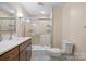 Well-lit bathroom featuring a glass-enclosed shower, a vanity with a sink, and neutral color tones at 1252 Wendy Rd, Rock Hill, SC 29732