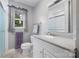 Bright bathroom featuring a vanity, mirror and a window with a view of trees at 1252 Wendy Rd, Rock Hill, SC 29732
