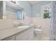 Well-lit bathroom featuring a vanity with a sink, a toilet, and a shower with blue accents at 1252 Wendy Rd, Rock Hill, SC 29732