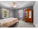 Cozy bedroom with carpet, ceiling fan, large windows, and a vintage-style armoire at 1252 Wendy Rd, Rock Hill, SC 29732