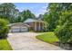 Charming brick home with white columns, two-car garage, and a spacious driveway surrounded by lush greenery at 1252 Wendy Rd, Rock Hill, SC 29732