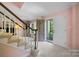 Bright and inviting foyer with staircase, coat closet and front door open to greenery at 1252 Wendy Rd, Rock Hill, SC 29732