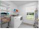 Bright laundry room with washer, dryer, and storage shelves near a window at 1252 Wendy Rd, Rock Hill, SC 29732