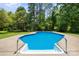 A beautiful swimming pool with a patio and trees surrounding the area at 1252 Wendy Rd, Rock Hill, SC 29732