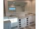 Bathroom featuring a large mirror, double sink vanity, marble countertop and modern white cabinets at 126 Zircon Dr, Statesville, NC 28625