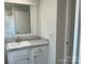Bathroom featuring a mirror and a single sink vanity with marble countertop and white cabinets at 126 Zircon Dr, Statesville, NC 28625