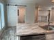 Kitchen island with stainless steel appliances, a barn door and modern finishes at 126 Zircon Dr, Statesville, NC 28625