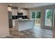 Modern kitchen featuring stainless steel appliances, island with sink, and sliding glass doors to a deck at 126 Zircon Dr, Statesville, NC 28625