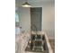 Close-up of a kitchen island with a stainless steel sink and a walk-in pantry in the background at 126 Zircon Dr, Statesville, NC 28625