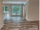 Open-concept living area with wood floors, and sliding doors to a deck at 126 Zircon Dr, Statesville, NC 28625