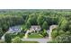 Beautiful home featuring manicured lawn and colorful landscaping, nestled among lush green trees at 132 Ragsdale Trl, Mooresville, NC 28117