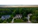 Aerial view of a home with lush greenery and mature trees in a desirable neighborhood at 132 Ragsdale Trl, Mooresville, NC 28117