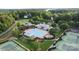 A community pool is surrounded by lounge chairs, umbrellas, clubhouse, tennis courts, and lush greenery at 132 Ragsdale Trl, Mooresville, NC 28117