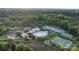 Aerial view of community clubhouse with swimming pool, tennis courts, and verdant surrounding trees at 132 Ragsdale Trl, Mooresville, NC 28117