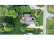 An aerial view of a well-maintained house with an outdoor seating area, surrounded by lush landscaping and trees at 132 Ragsdale Trl, Mooresville, NC 28117