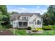 Expansive backyard featuring lush greenery, a patio seating area, and well-maintained landscaping at 132 Ragsdale Trl, Mooresville, NC 28117
