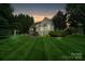Spacious backyard featuring a patio, lush green lawn, and mature trees at 132 Ragsdale Trl, Mooresville, NC 28117