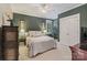 Comfortable bedroom featuring a decorative ceiling fan, floral arrangement, and natural light at 132 Ragsdale Trl, Mooresville, NC 28117