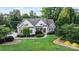 Charming home with a well-manicured lawn, stone accents, and mature trees at 132 Ragsdale Trl, Mooresville, NC 28117
