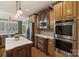 Well-equipped kitchen with stainless steel appliances, custom cabinets, and center island at 132 Ragsdale Trl, Mooresville, NC 28117