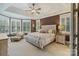 Spacious main bedroom features a large bed, sitting area, and many windows for ample natural light at 132 Ragsdale Trl, Mooresville, NC 28117
