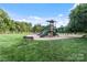 Well-maintained playground area with slides, climbing structures, and surrounding grassy area, all enclosed by a fence at 132 Ragsdale Trl, Mooresville, NC 28117