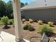 Landscaped backyard featuring a black metal fence and colorful flowering bushes at 1330 Millview Ln, Matthews, NC 28104