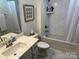 Well-lit bathroom featuring marble-look tiling, neutral color palette, and modern fixtures for a clean, spa-like feel at 1330 Millview Ln, Matthews, NC 28104