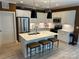 Modern kitchen featuring white cabinets, stainless steel appliances, and a center island with breakfast bar seating at 1330 Millview Ln, Matthews, NC 28104