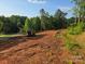 Cleared and partially graded lot ready for construction with some trees surrounding the back at 138 Broken Arrow Rd, Statesville, NC 28677