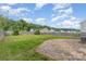 Fenced backyard with a grassy area, stone patio, and lush greenery at 1404 Waylon Ave, Gastonia, NC 28054
