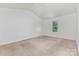 Bright bedroom features a neutral carpet and window with a view of outside at 1404 Waylon Ave, Gastonia, NC 28054