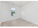 Well-lit bedroom with a neutral carpet and window view of the neighborhood at 1404 Waylon Ave, Gastonia, NC 28054