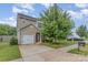 Charming two-story home with landscaped front yard, paved driveway, and attached one car garage at 1404 Waylon Ave, Gastonia, NC 28054