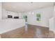 Living room with dining area and modern kitchen featuring granite countertops at 1404 Waylon Ave, Gastonia, NC 28054