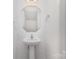 Stylish powder room featuring pedestal sink, decorative mirror, and modern fixtures at 1404 Waylon Ave, Gastonia, NC 28054