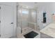 Modern bathroom featuring a tiled walk-in shower with a built-in bench and glass door at 14116 Glaswick Dr, Charlotte, NC 28278