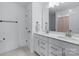 Bright bathroom with a double vanity, modern fixtures, and clean, white cabinets at 14116 Glaswick Dr, Charlotte, NC 28278