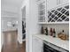 Elegant butler's pantry boasts custom wine rack, beverage cooler, and seamless access to the home's living spaces at 14116 Glaswick Dr, Charlotte, NC 28278
