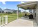 Relaxing covered patio area perfect for outdoor seating with fan and backyard view at 14116 Glaswick Dr, Charlotte, NC 28278